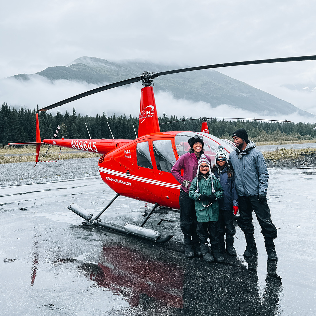 The Mall family standing in front of a helicopter